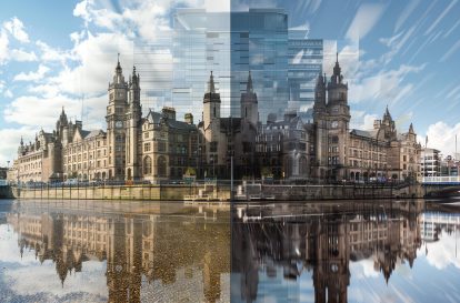 A stunning cityscape of a modern glass skyscraper reflecting the historic buildings of a city.